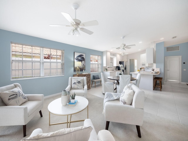 living room featuring ceiling fan and light tile patterned floors