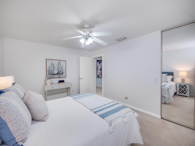 bedroom featuring light carpet and ceiling fan