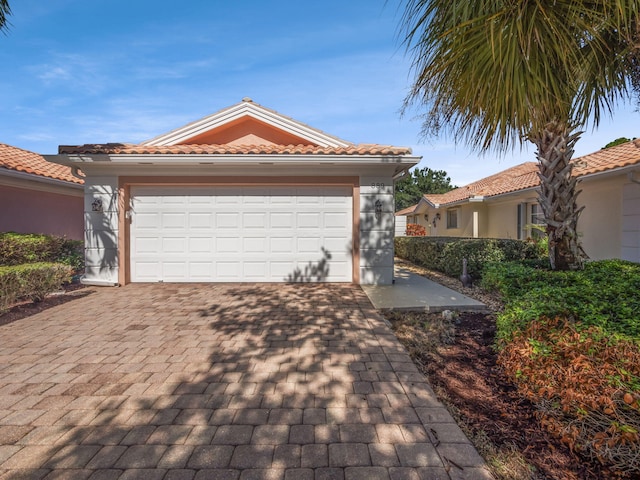 mediterranean / spanish-style home with a garage