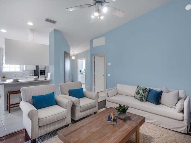 living room featuring ceiling fan, hardwood / wood-style floors, and high vaulted ceiling