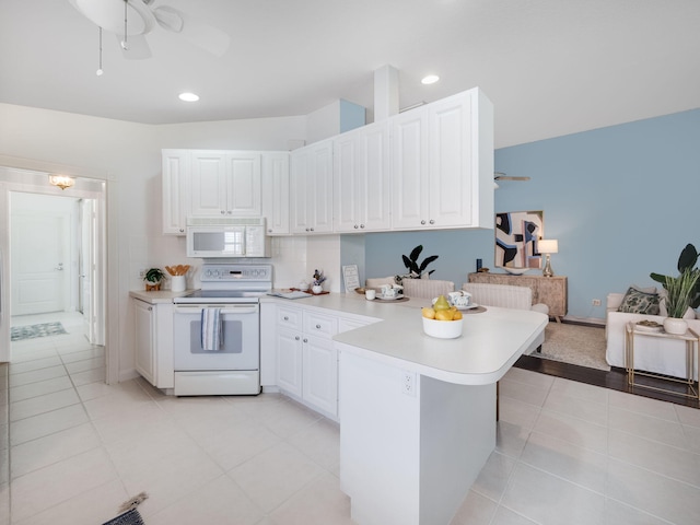 kitchen featuring white cabinetry, white appliances, kitchen peninsula, light tile patterned floors, and ceiling fan