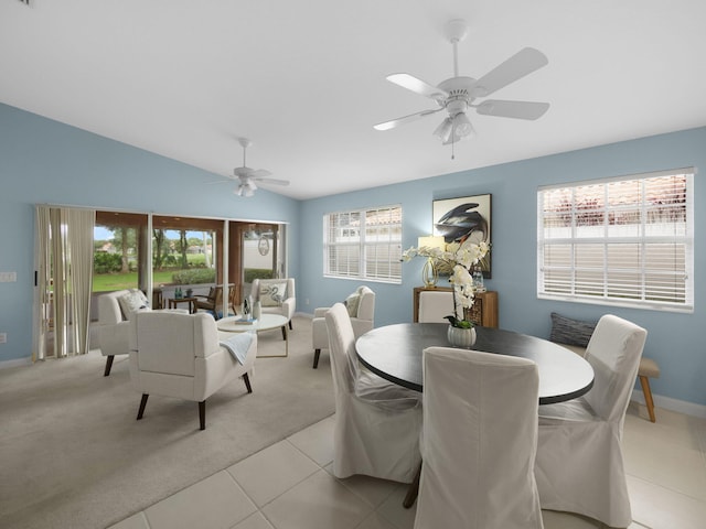 tiled dining space with ceiling fan and sink