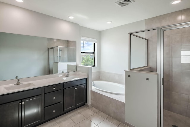 bathroom featuring plus walk in shower, tile patterned flooring, and vanity