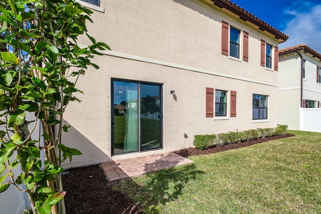 rear view of property featuring a yard