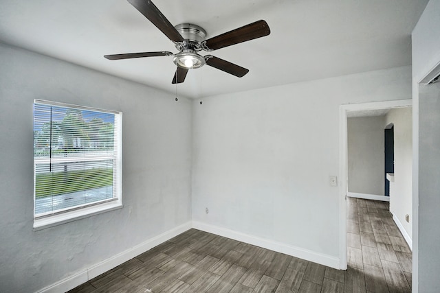 unfurnished room with dark hardwood / wood-style floors and ceiling fan