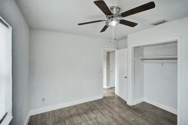 unfurnished bedroom featuring hardwood / wood-style floors, a closet, and ceiling fan