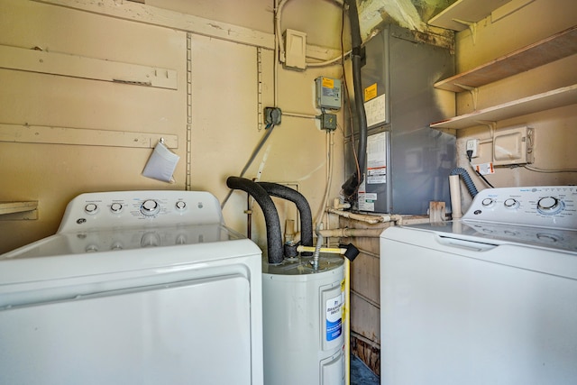 clothes washing area with electric water heater and washer and clothes dryer