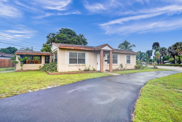 ranch-style home featuring a front yard