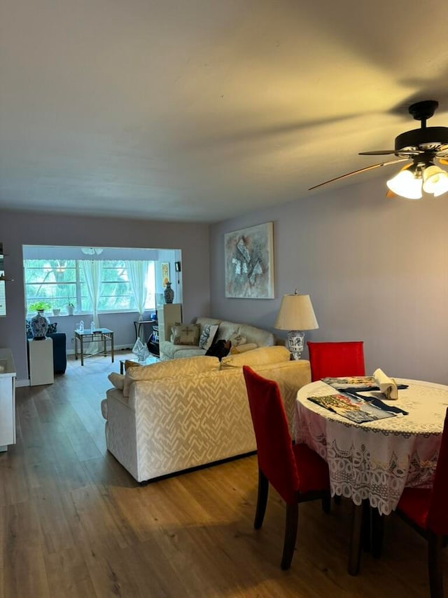 dining room with hardwood / wood-style floors and ceiling fan