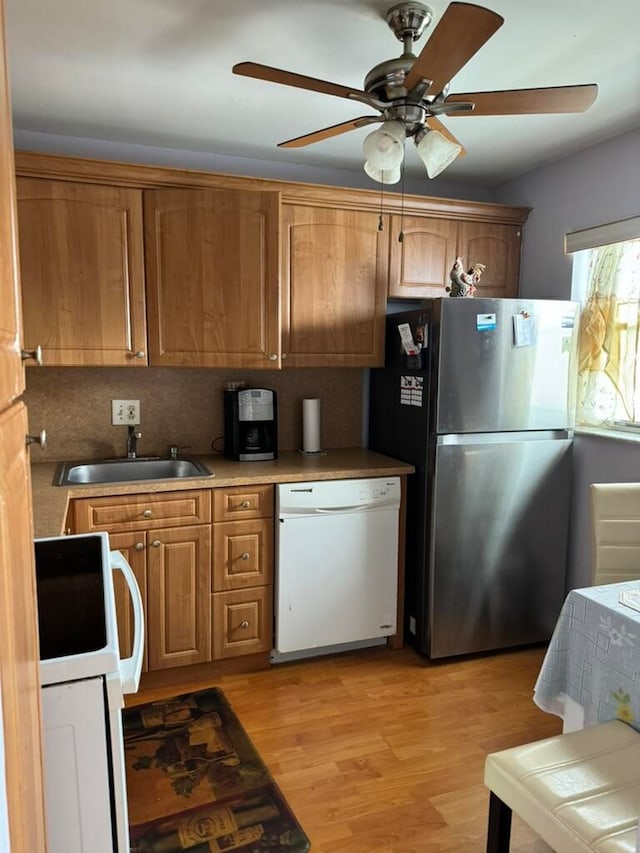 kitchen with ceiling fan, light wood-type flooring, sink, and white appliances