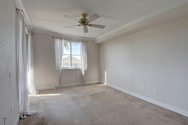 carpeted empty room with ornamental molding and ceiling fan