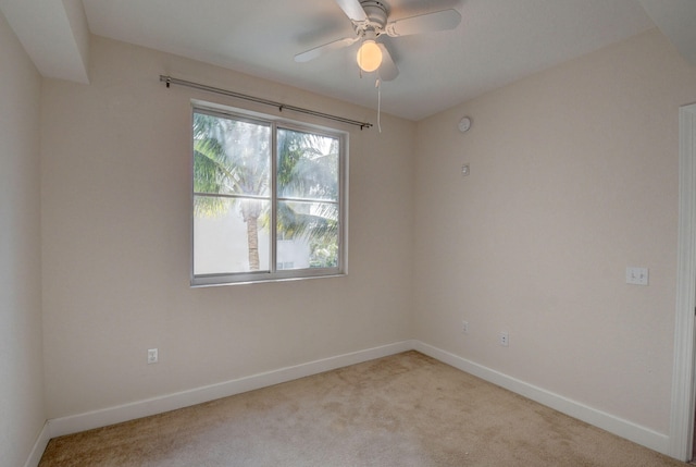 unfurnished room with ceiling fan and light carpet