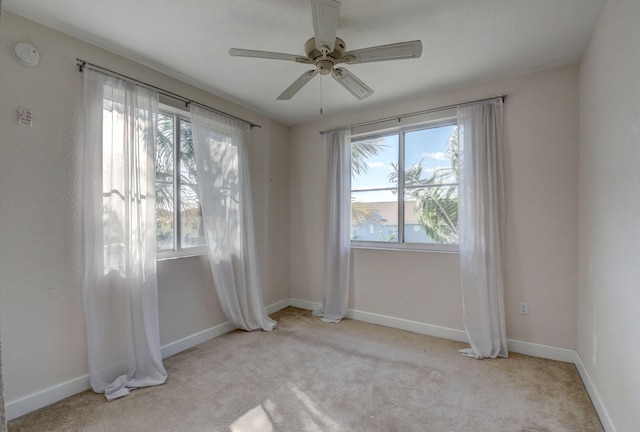 carpeted empty room with ceiling fan