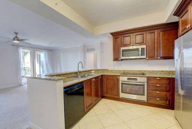 kitchen featuring light stone counters, sink, black appliances, kitchen peninsula, and ceiling fan