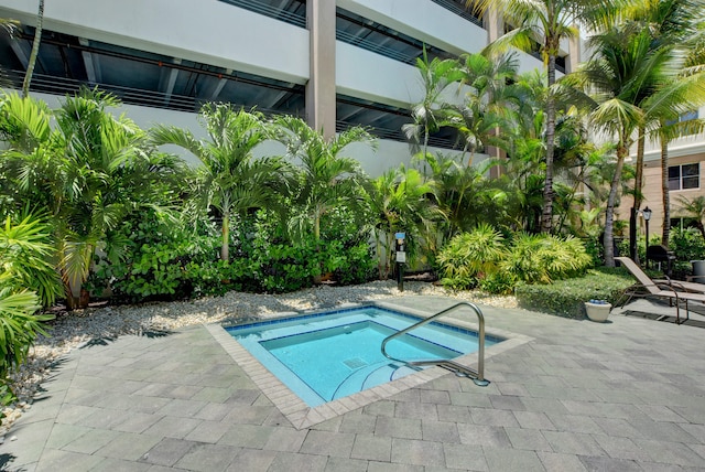 view of pool featuring an in ground hot tub and a patio