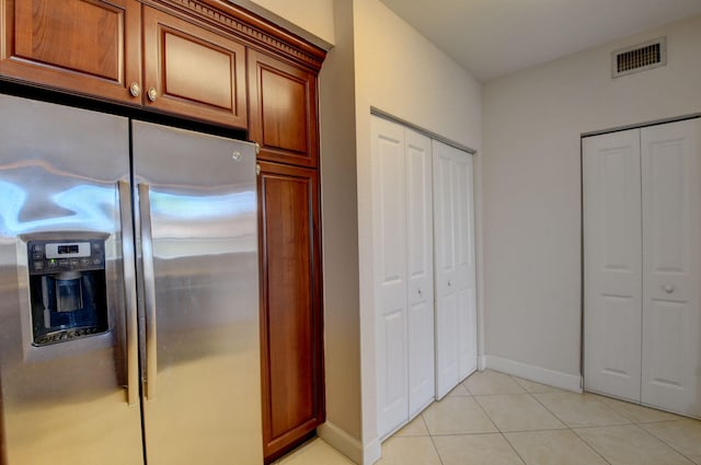 kitchen with light tile patterned floors and stainless steel fridge with ice dispenser