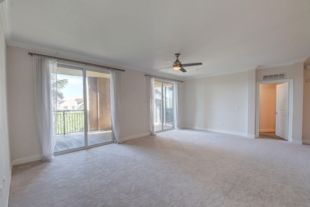 empty room featuring ceiling fan, light carpet, and ornamental molding