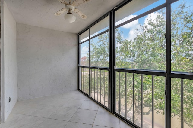 unfurnished sunroom featuring ceiling fan