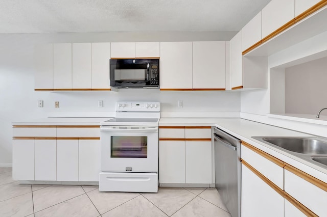 kitchen featuring dishwasher, light tile patterned floors, electric range, sink, and white cabinets