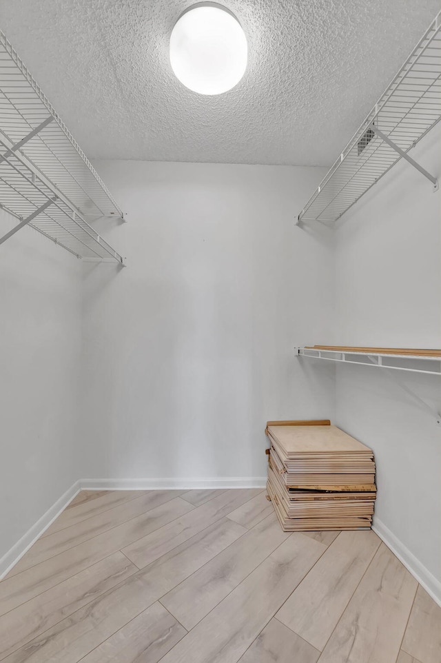 spacious closet featuring light hardwood / wood-style floors