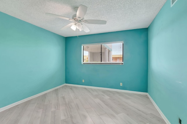 empty room featuring a textured ceiling, ceiling fan, and light hardwood / wood-style floors