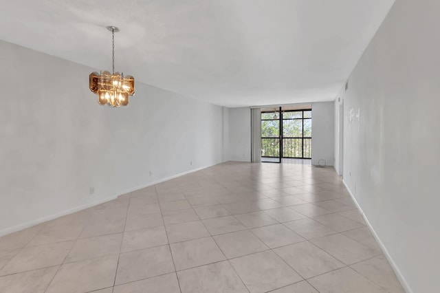 tiled empty room featuring a wall of windows and a notable chandelier