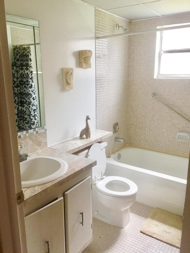 full bathroom with vanity, toilet, tile patterned floors, and shower / bath combo with shower curtain