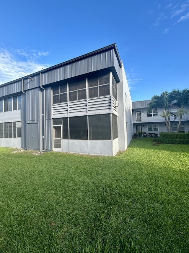 rear view of property featuring a yard