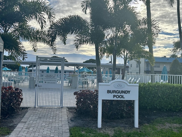 view of home's community featuring fence