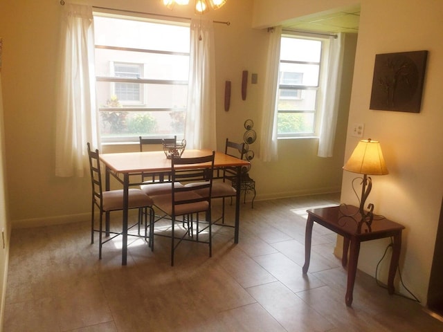 tiled dining space featuring baseboards