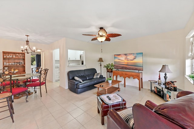 tiled living room with ceiling fan with notable chandelier