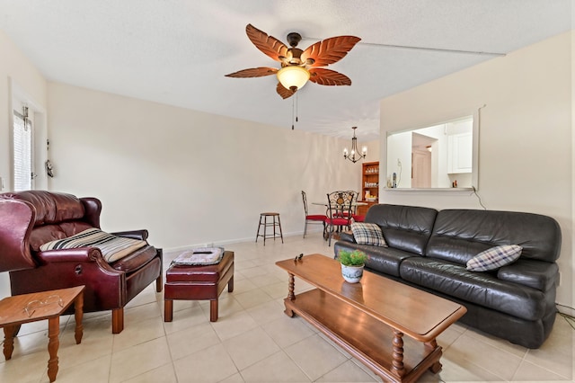 tiled living room with ceiling fan with notable chandelier