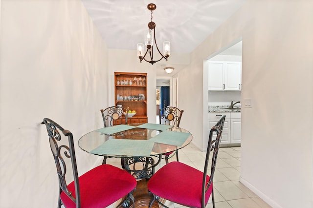 tiled dining space featuring an inviting chandelier and sink