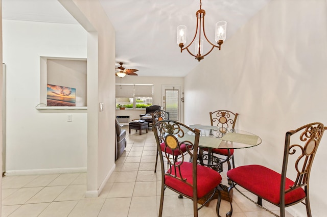 tiled dining room with ceiling fan with notable chandelier