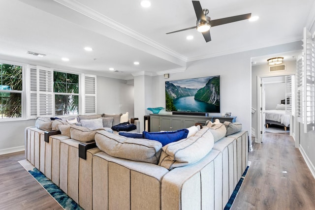 living room with crown molding, light hardwood / wood-style flooring, and ceiling fan