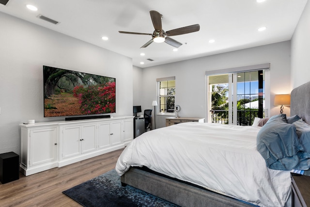 bedroom with ceiling fan, dark hardwood / wood-style flooring, and access to exterior