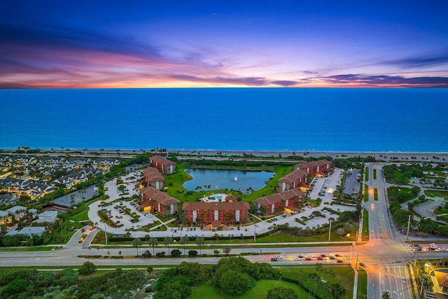 aerial view at dusk with a water view