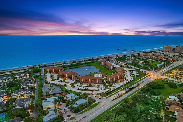 aerial view at dusk with a water view