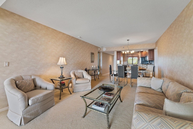 living room with a textured ceiling, a chandelier, and light colored carpet