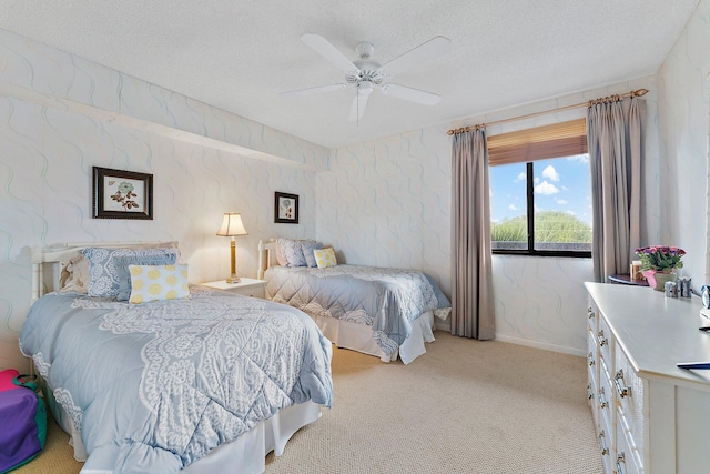 bedroom featuring light carpet, a textured ceiling, and ceiling fan