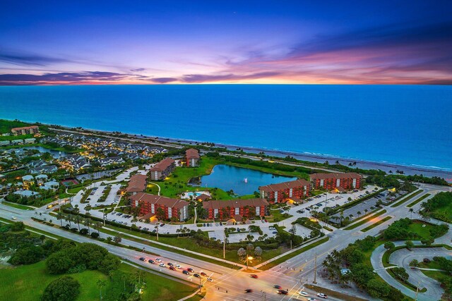 aerial view at dusk with a water view