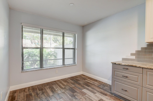 unfurnished dining area with dark hardwood / wood-style floors