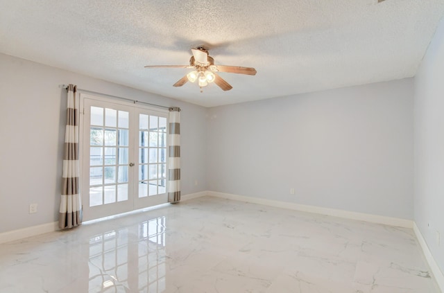 empty room with ceiling fan, french doors, and a textured ceiling