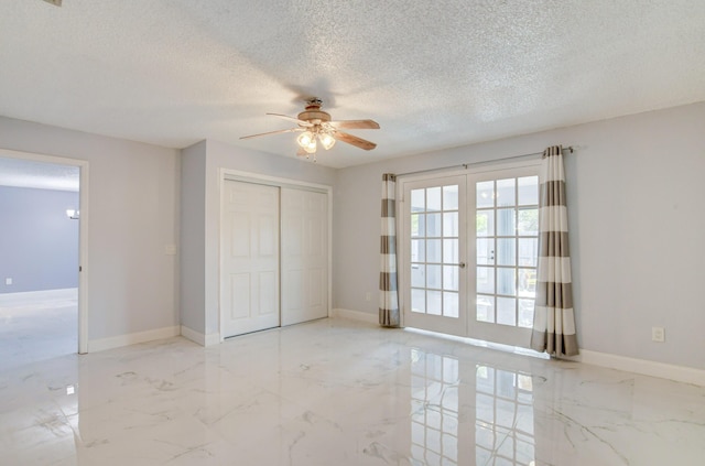 unfurnished bedroom with ceiling fan, french doors, a textured ceiling, and a closet