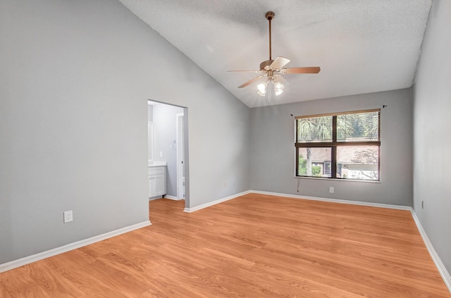 unfurnished room with ceiling fan, a textured ceiling, high vaulted ceiling, and light hardwood / wood-style flooring