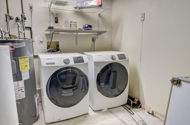 clothes washing area with washing machine and clothes dryer and water heater