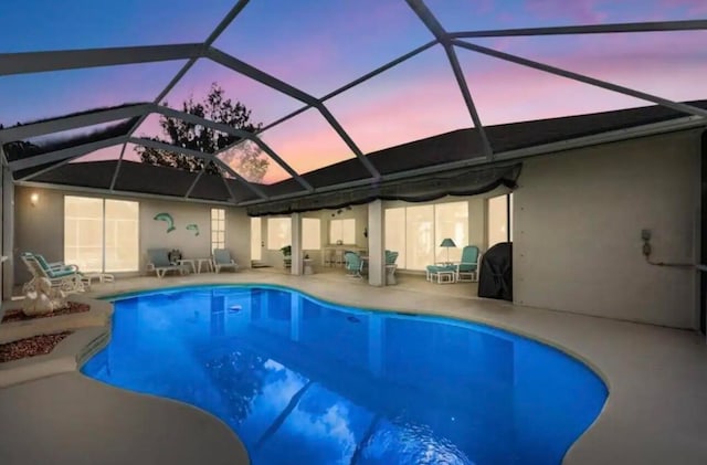 outdoor pool with a patio and a lanai