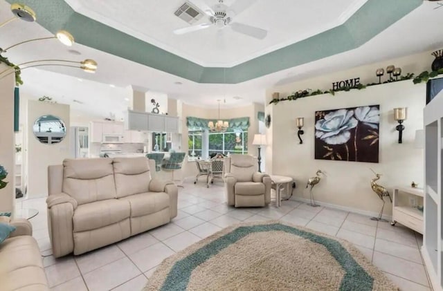 living area featuring baseboards, ceiling fan with notable chandelier, a raised ceiling, and light tile patterned flooring