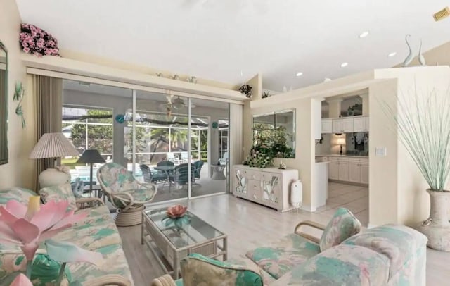 living room with recessed lighting, a sunroom, and visible vents