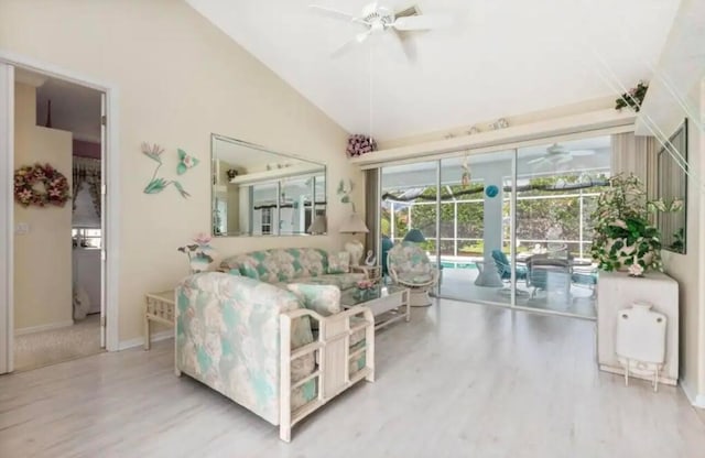 living room with lofted ceiling, a sunroom, ceiling fan, and wood finished floors